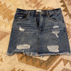 Distressed denim mini skirt